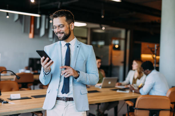 istock Businessman texting on his phone in the office. 2169869891