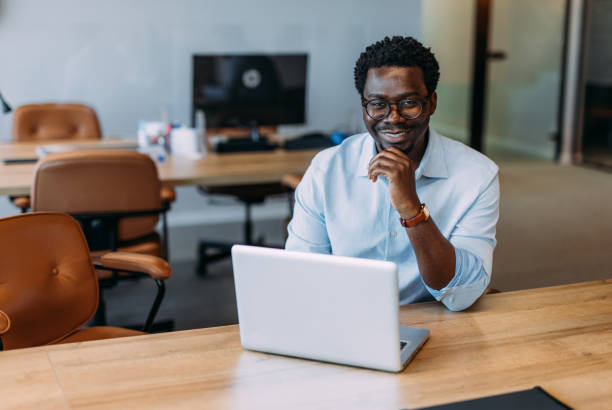 istock Successful businessman in modern office working on laptop. 2169869969