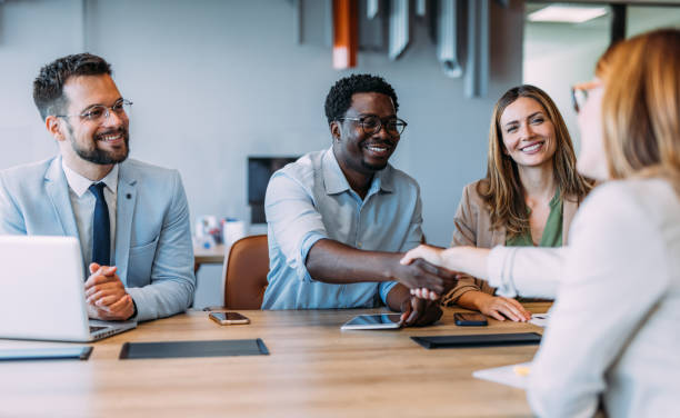 istock Businesspeople shaking hands across the table. 2169870003