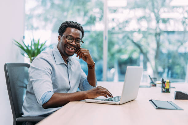 istock Successful businessman in modern office working on laptop. 2169870038