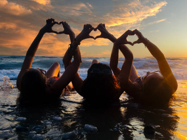 istock Silhouette women making heart with hands at sunset 2169872957