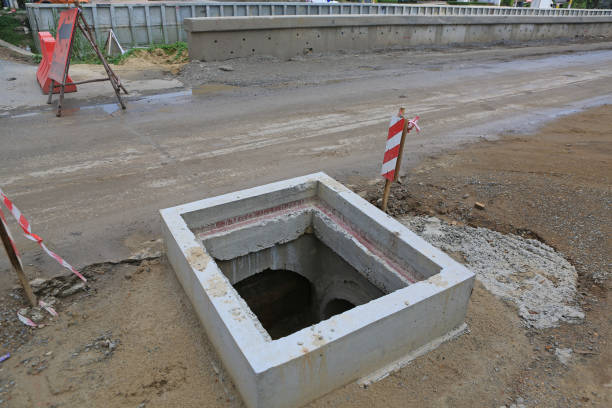 istock Manhole cover on concrete road in progress. 2169873110