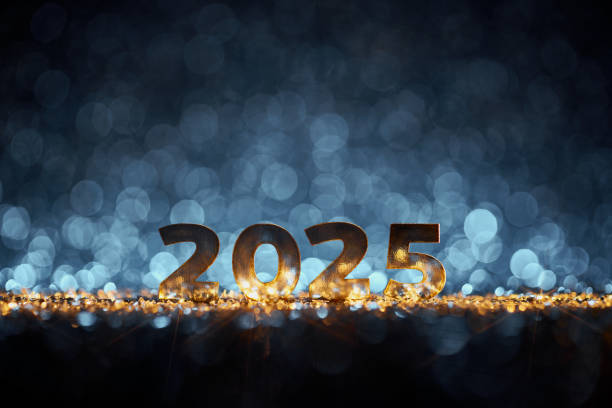 istock Glowing golden 2025 numbers on a dark surface surrounded by bokeh lights, creating a magical New Year's Eve celebration vibe. 2169873983