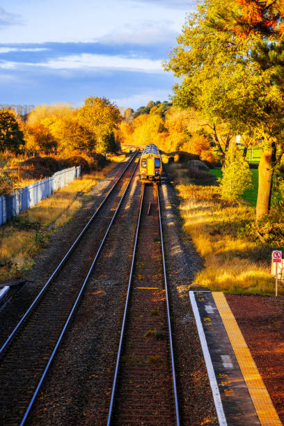 Rural railway station Autumn Midlands UK Passenger commuter train arriving at rural country station with autumn colour surrounding it.