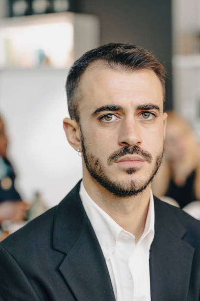 istock Serious businessman making eye contact in office space 2169876217