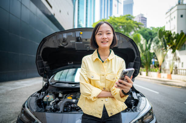 istock Staying Positive: Happy Woman Awaits Help After Car Breakdown 2169878592