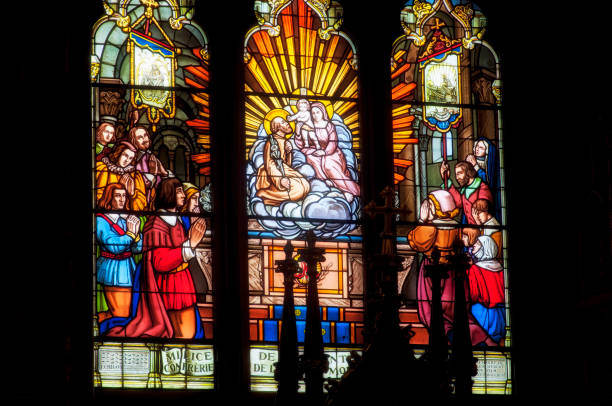 A stained glass window with a religious scene within notre dame cathedral in montreal canada.