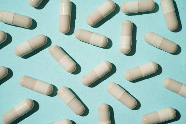 istock Group of pills capsules, the nutritional supplements, vitamins medicine tablets on blue background 2169880331