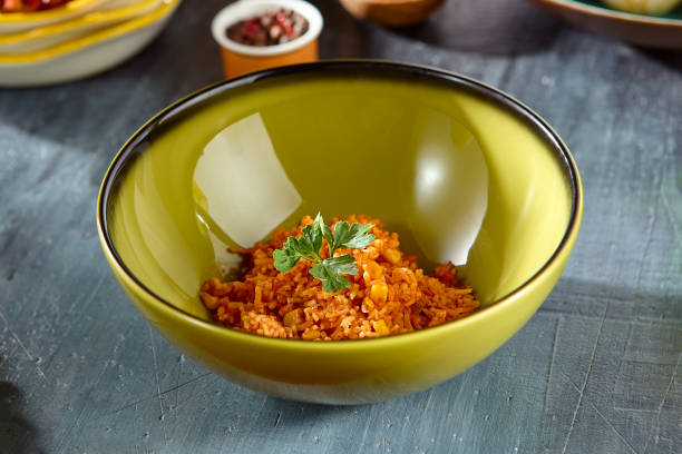 istock Mexican Corn Rice Dish in Green Bowl on Rustic Wooden Table 2169880435
