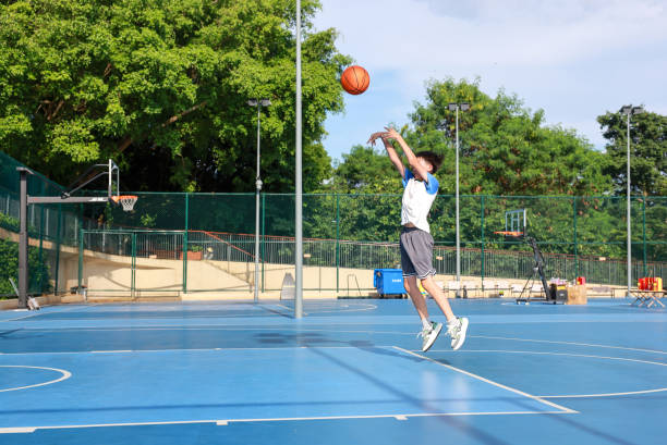istock Cute Asian boy playing basketball 2169883670