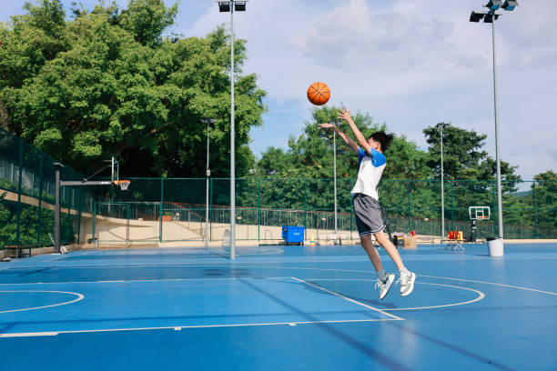 istock Cute Asian boy playing basketball 2169883689