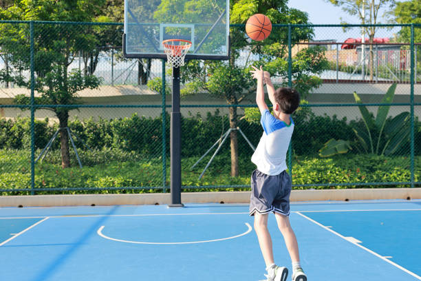 istock Cute Asian boy playing basketball 2169883717