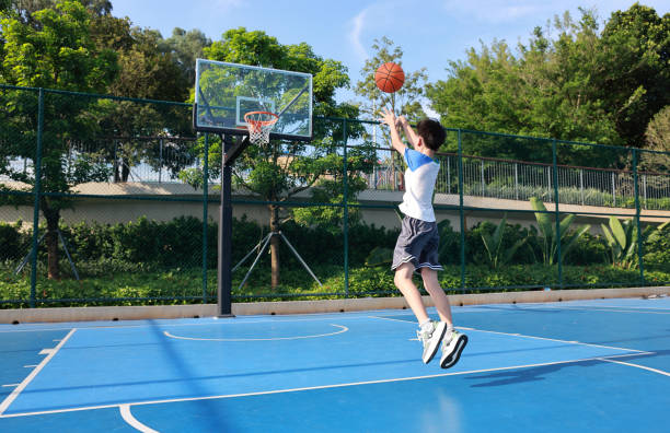 istock Cute Asian boy playing basketball 2169883727