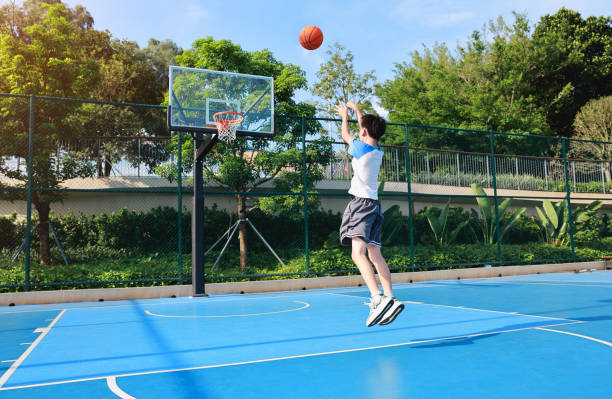 istock Cute Asian boy playing basketball 2169883757