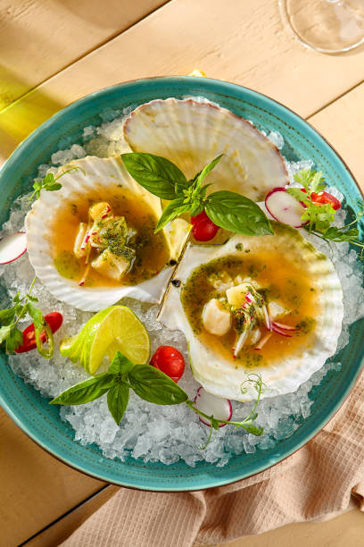 istock Scallop Ceviche on Ice with Fresh Herbs and Garnishes on a Ceramic Plate 2169893489