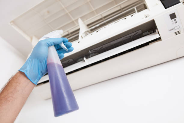 istock Man cleaning and maintaining air condition unit at home. 2169893717