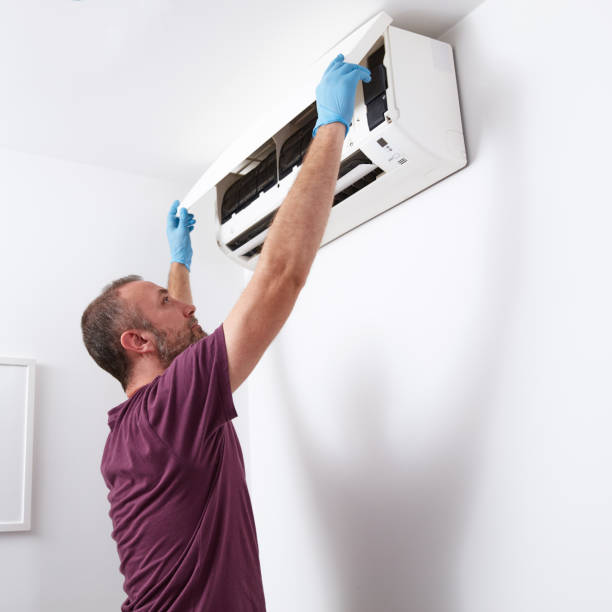 istock Man cleaning and maintaining air condition unit at home. 2169893763