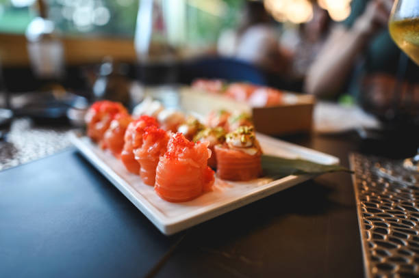 istock Close up salmon sushi rolls on a table. 2169898591