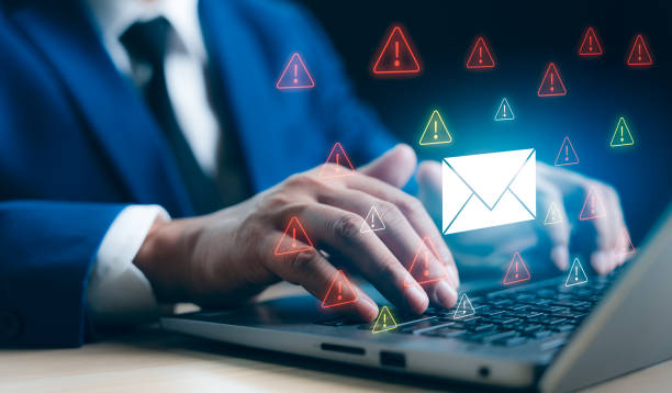 istock A Businessman working on a laptop open an email with triangle caution warning sign for notification error and maintenance concept, network security, computer virus detected, personal data protection. 2169899585