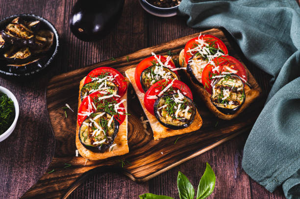 istock Vegetarian bruschetta with grilled eggplant, tomatoes and cheese on a board 2169899763