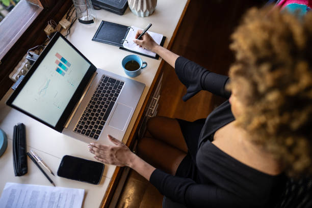 istock Young woman working using laptop at home 2169902799