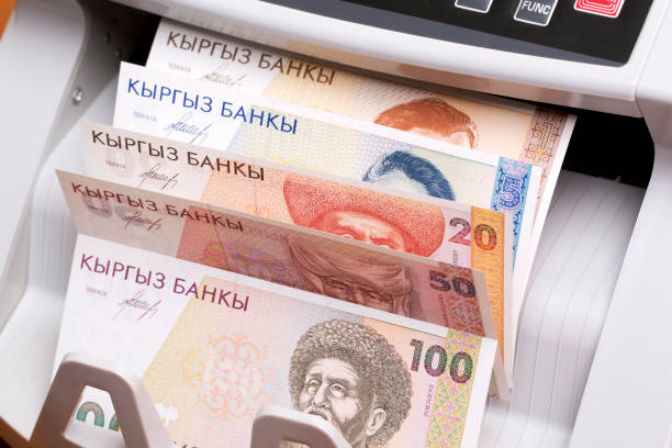 istock Old Kyrgyz som in the counting machine 2169902822