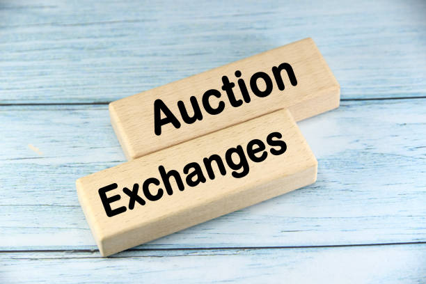 istock Auction Exchanges wording  or text on wood block with blue background.Copy space and business concept. 2169903190