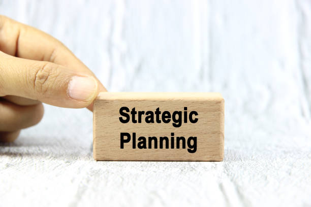 istock Strategic planning wording or text on wood block with hand on white background.Copy space and business concept. 2169903249