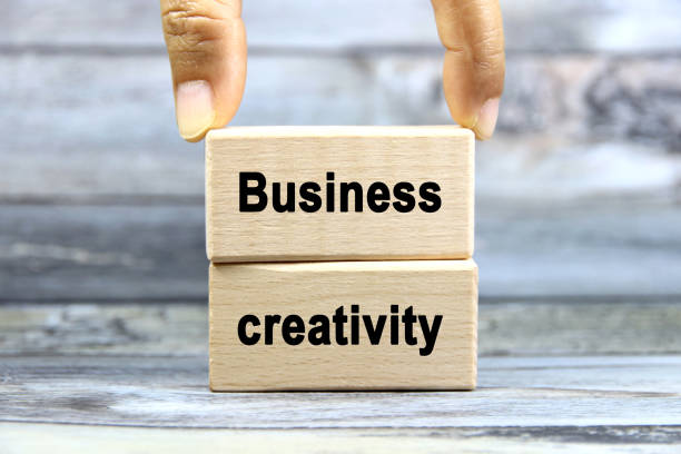 istock Business creativity wording or text on wood block with hand on grey background.Copy space and business concept. 2169903256