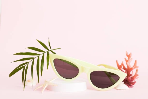 istock sunglasses with seashell lying on table background. Sunglasses on summer background. Top view flat lay with copy space for text 2169903459