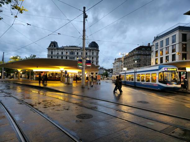 Zurich Bellevue City Square with (Tram / Cable Cars). The image was captured during spring season at dusk.