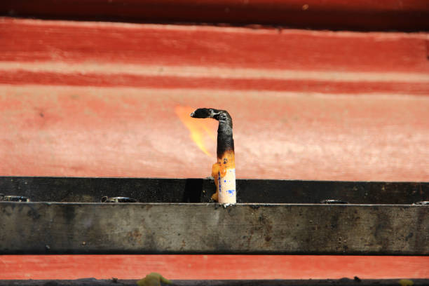 A single candle with flame in a temple in Thailand.