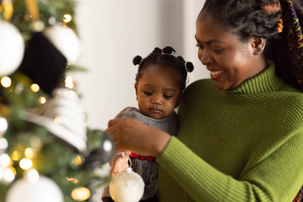 istock Woman Decorating Christmas Tree 2169909097
