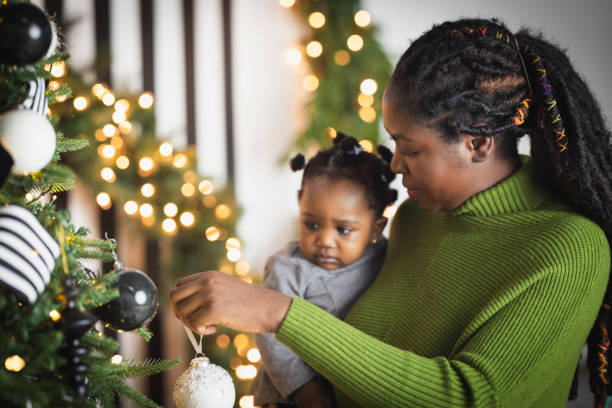 istock Woman Decorating Christmas Tree 2169909100
