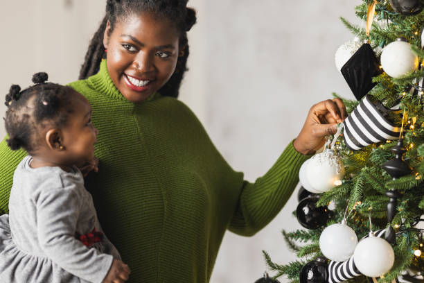 istock Woman Decorating Christmas Tree 2169909120