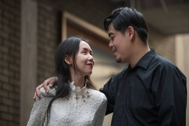 Asian young couple looking each other, male and female spending time together