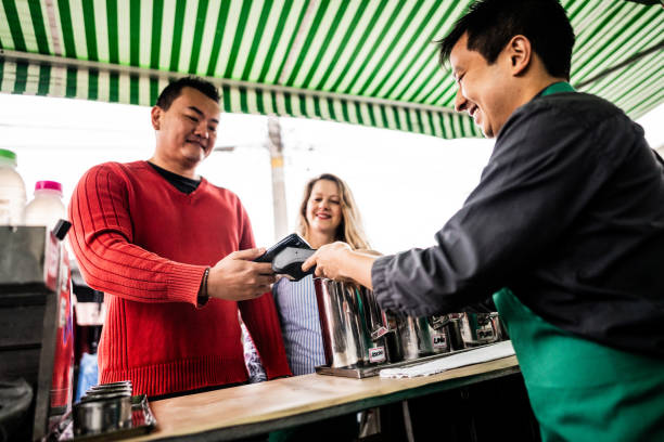 istock Customer making payment using a mobile phone app at a street kiosk 2169910556