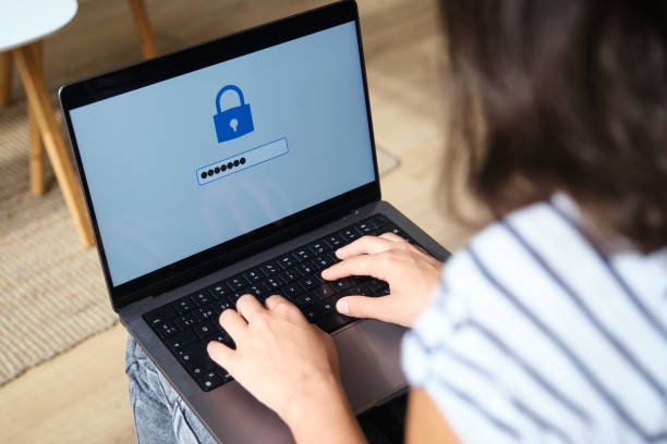 istock Woman entering password on laptop for online security 2169912749