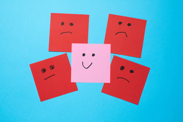Colorful paper signs expressing emotions creatively arranged on a blue background