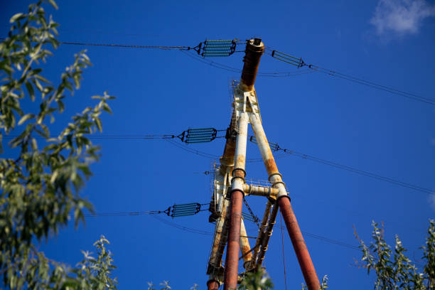 Huge metal power pole against the blue sky