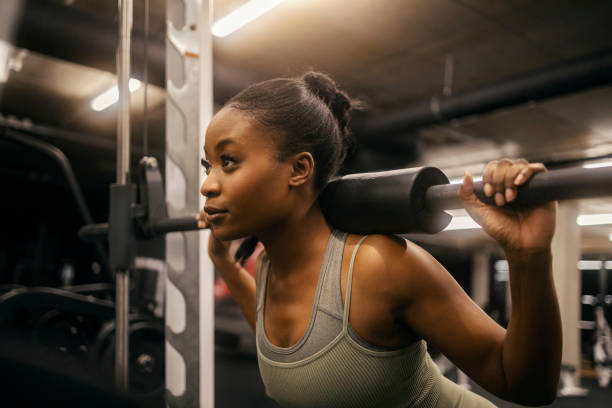 istock A young black sportswoman doing workouts on smith machine at gym. 2169920781