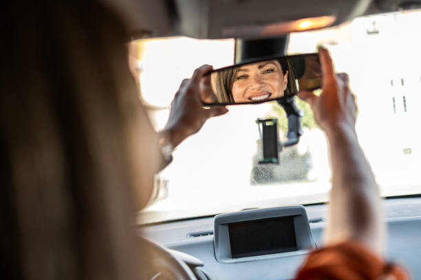 istock Female Driver Adjusts Rear-View Mirror for a Perfect Angle 2169920928