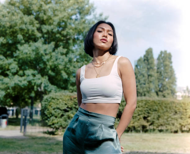 istock Confident asian woman posing in a park. 2169921255
