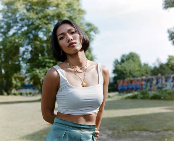 istock Relaxed young woman looking at camera in a park. 2169921260
