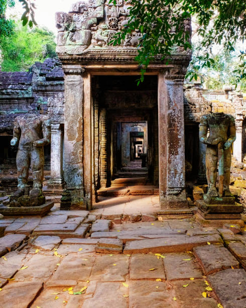 istock Time-worn sentinels: Two damaged ancient sculptures flank Preah Khan's medieval Buddhist temple entry. 2169924235