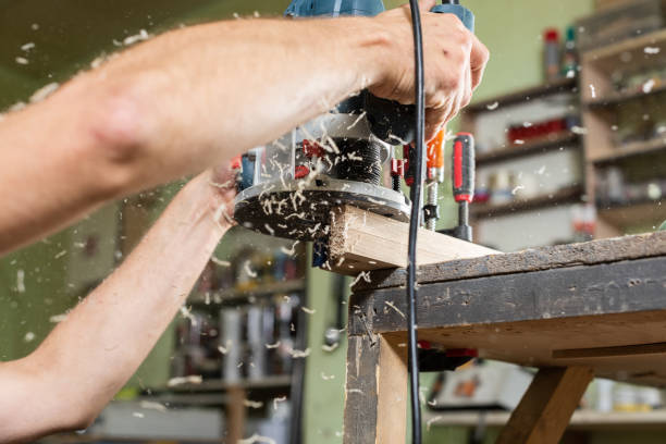 istock The carpenter is milling the part with a hand-held milling cutter 2169930491