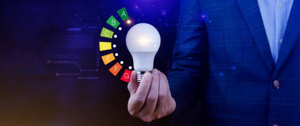 istock Energy efficiency concept, House energy efficiency or energy saving rate for reduce carbon footprint, hold light bulb with energy efficient rating class concept save cost green energy. 2169932908