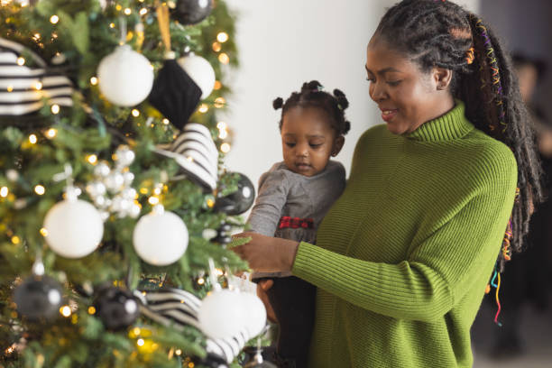 istock Woman Decorating Christmas Tree 2169934877