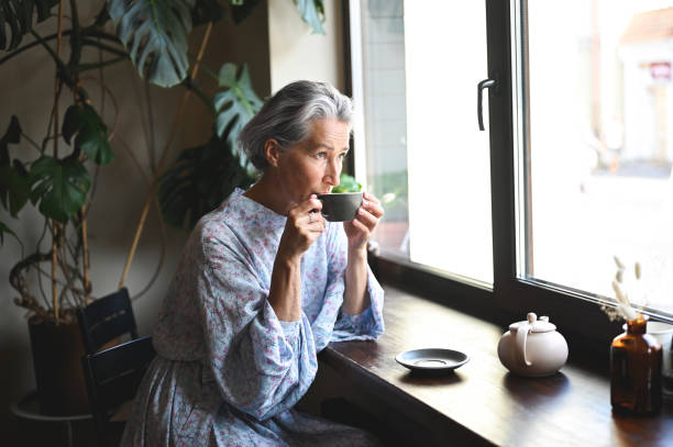 Candid beautiful woman drinking hot tea.
