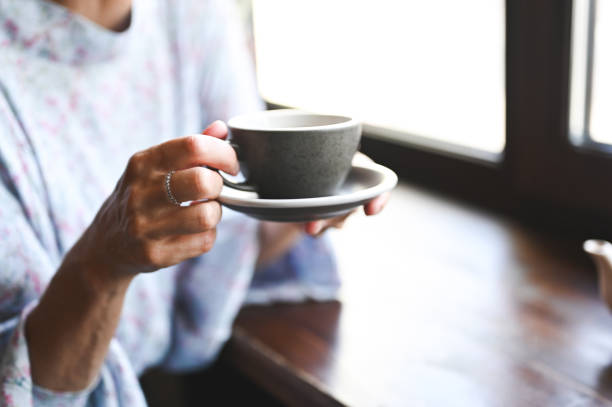Close up of a woman drinking tea.